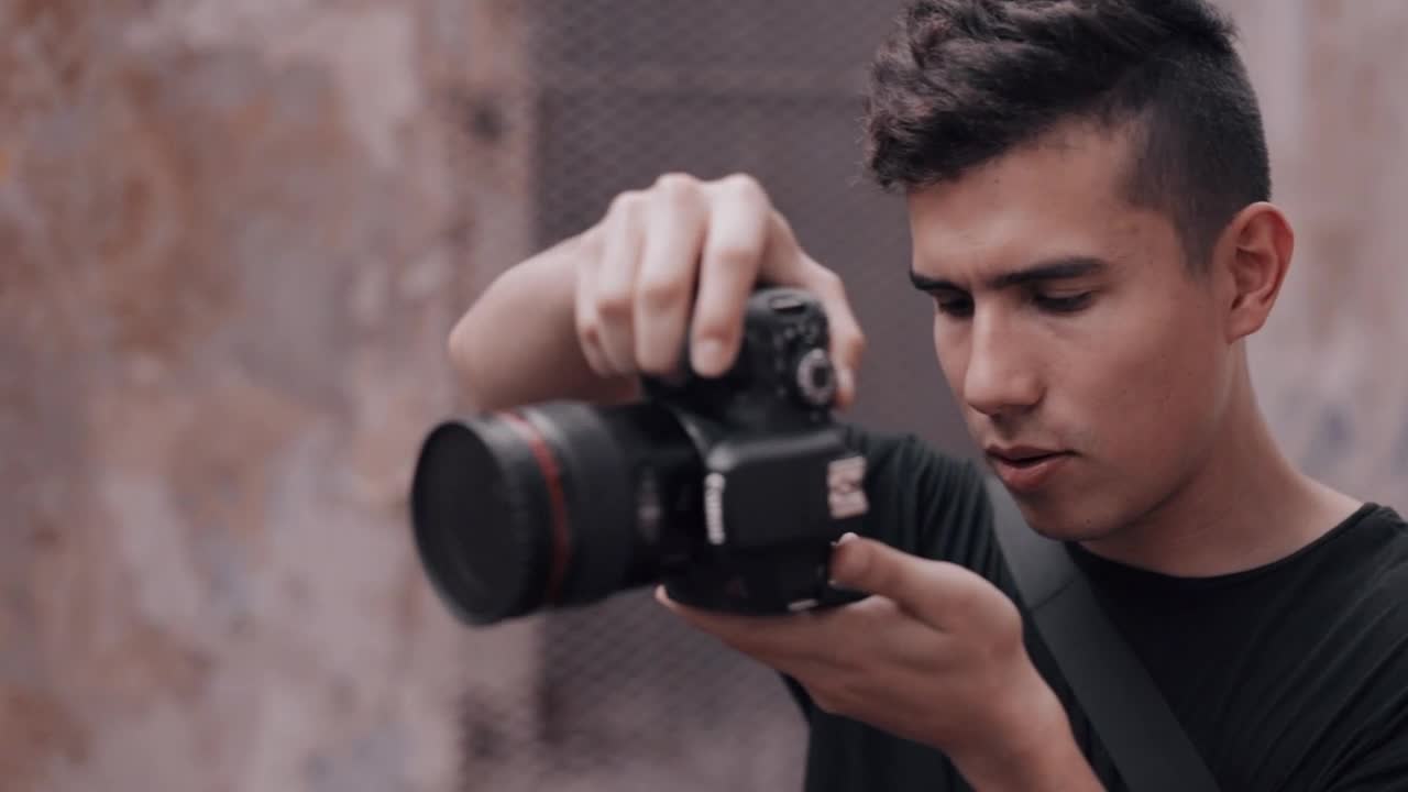 Video Stock Photographer Reviewing His Shots In The Cameras Screen Live Wallpaper Free