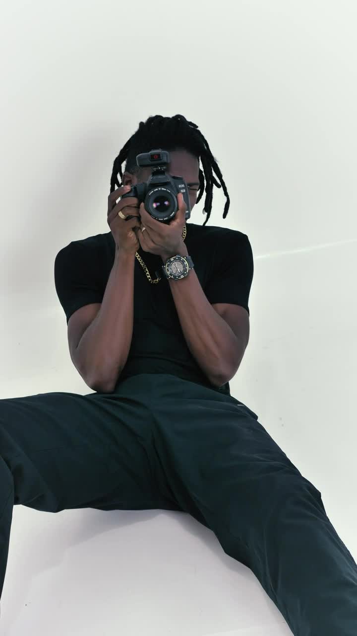 Video Stock Photographer Sitting On The Floor On A White Background Live Wallpaper Free