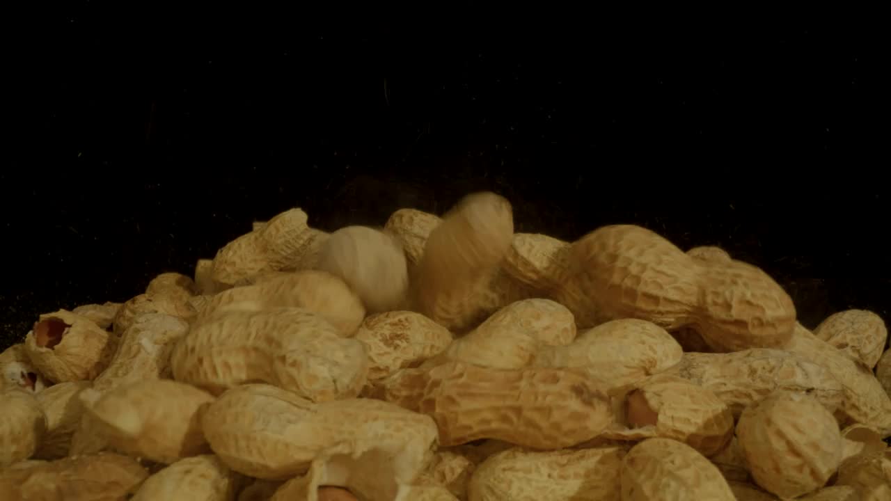 Video Stock Pile Of Peanuts On A Black Background Live Wallpaper Free