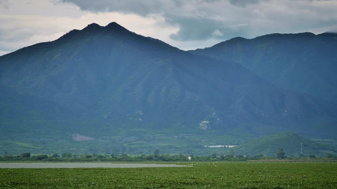 Video Stock Plain With A Lake Surrounded By Large Sunny Mountains  LargeLive Wallpaper Free