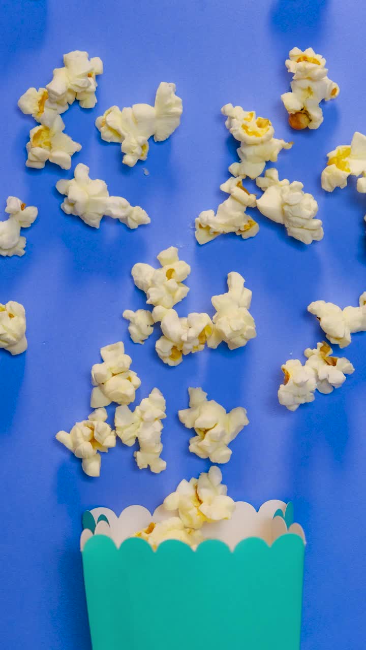 Video Stock Popcorn Scattered In Stop Motion On A Blue Background Live Wallpaper Free