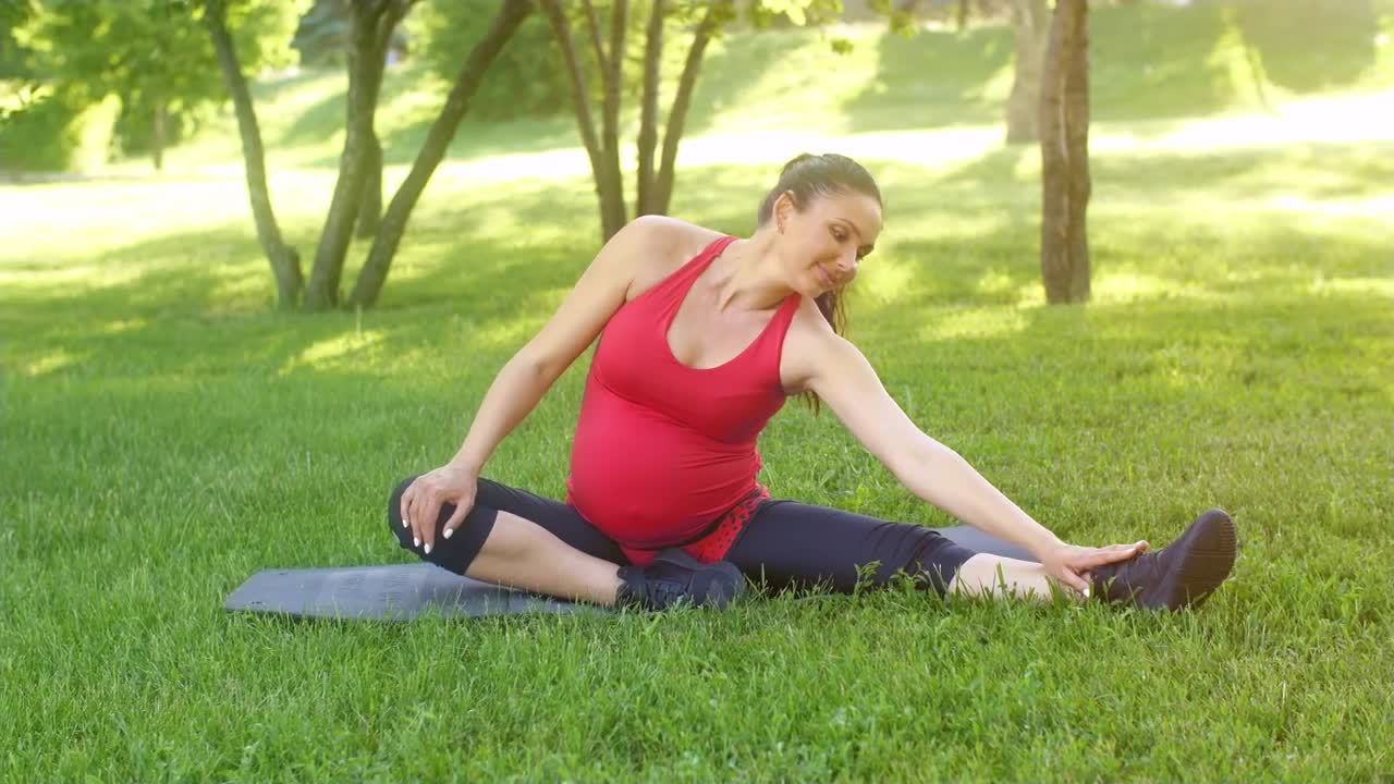 Video Stock Pregnant Woman Does Stretching On The Grass Live Wallpaper Free