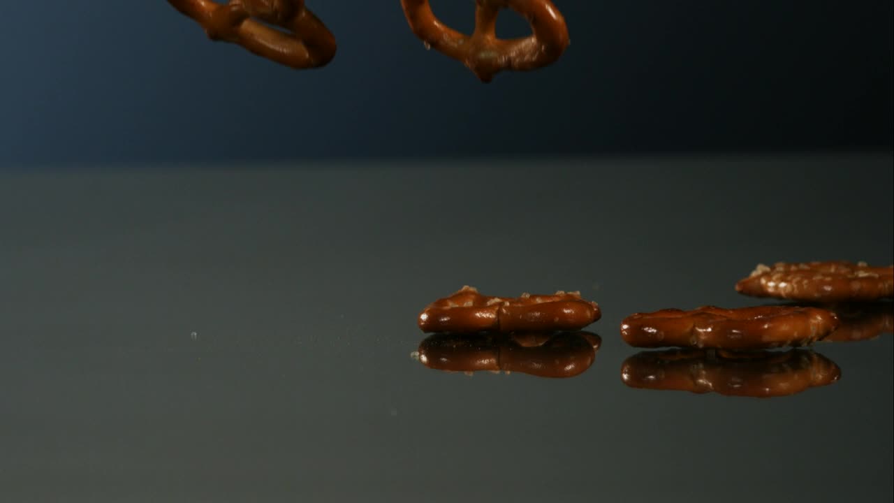 Video Stock Pretzels Falling Into A Mirror Surface Live Wallpaper Free