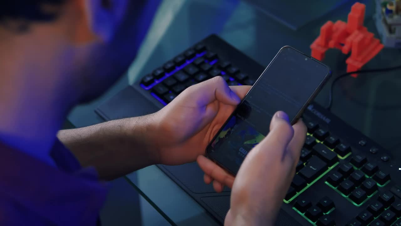 Video Stock Programmer Using His Cell Phone While Working At His Desk Live Wallpaper Free