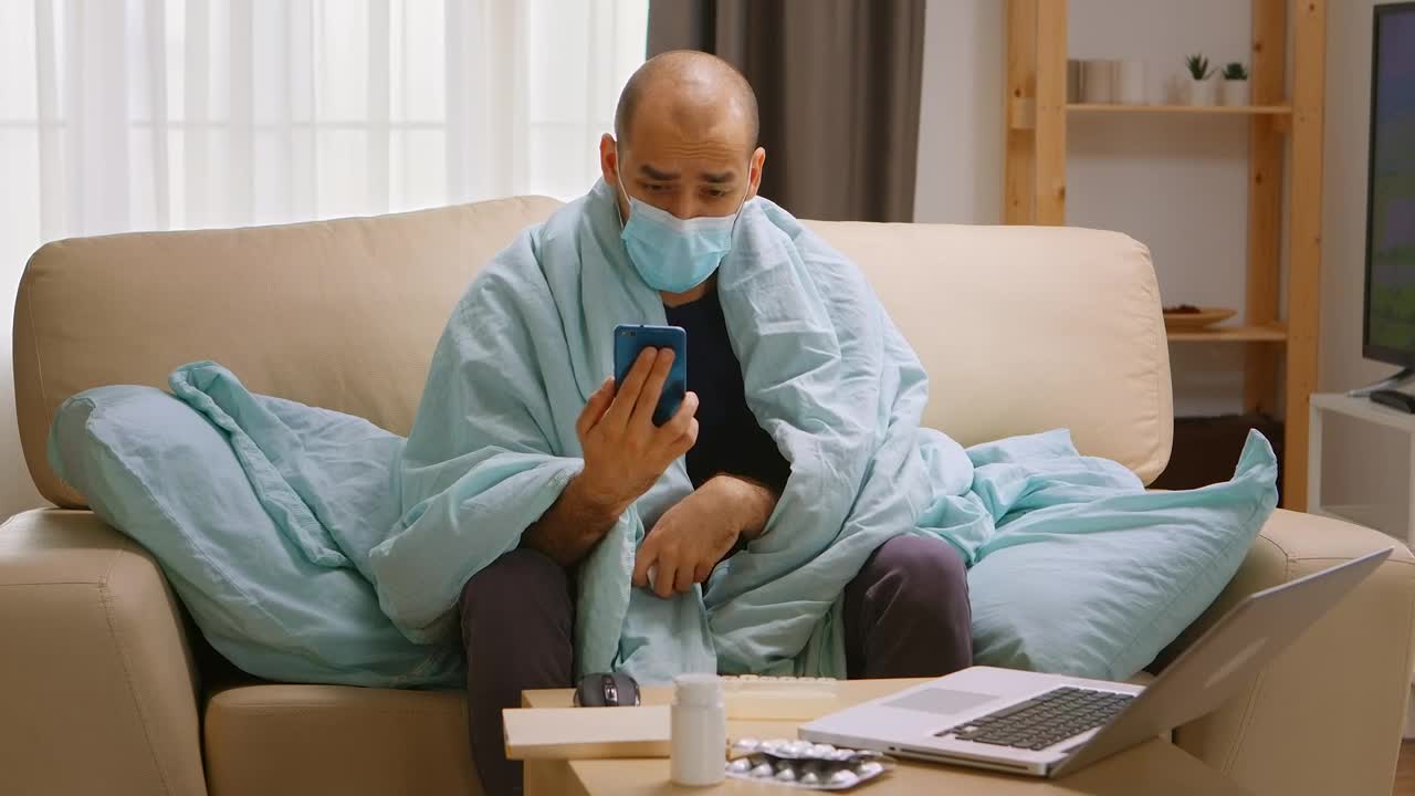 Video Stock Quarantined Man With Smartphone Video Chats On Sofa Live Wallpaper Free