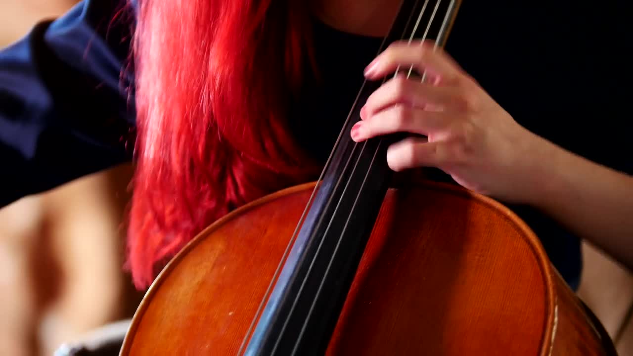 Video Stock Red Haired Woman Playing The Cello Live Wallpaper Free