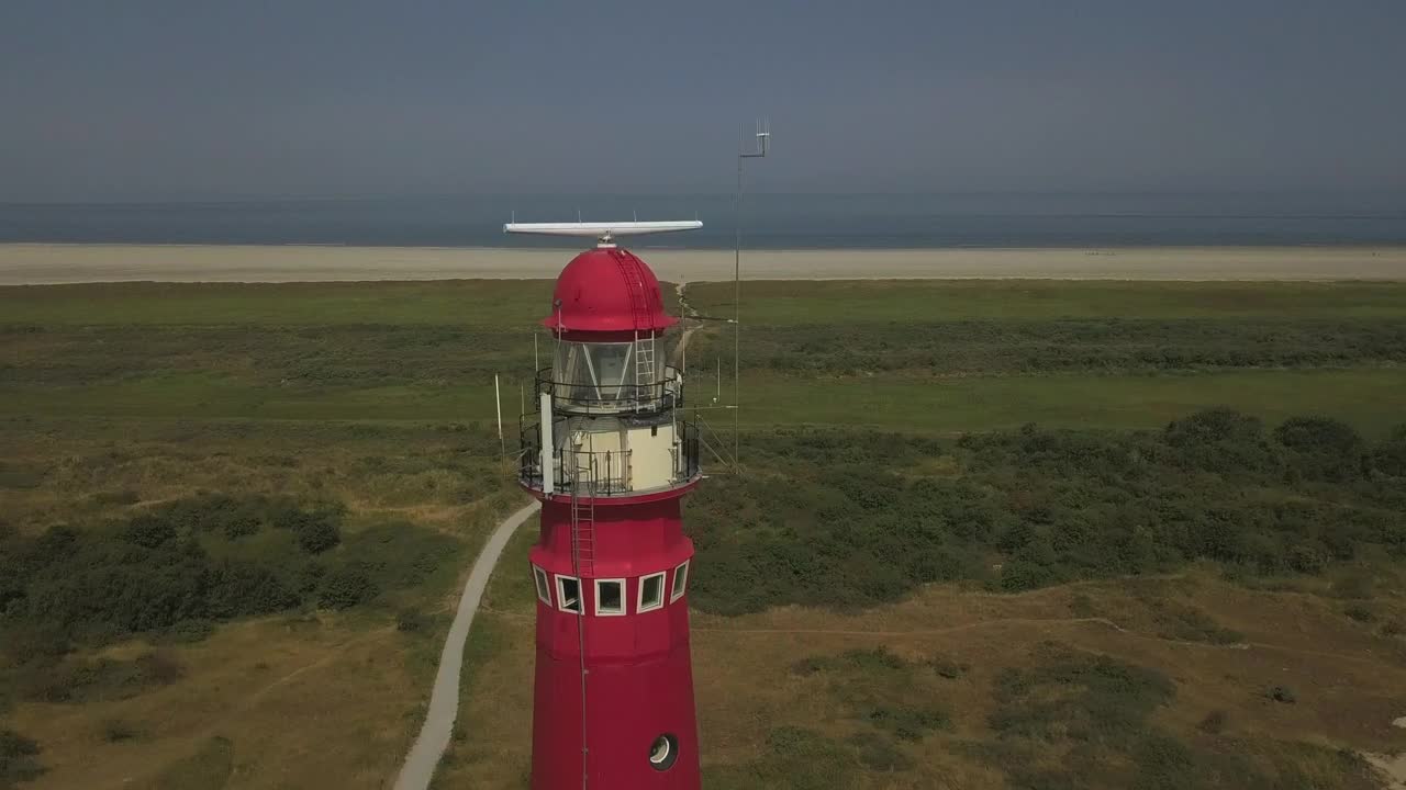 Video Stock Red Lighthouse Near The Shore Spinning Aerial Shot Live Wallpaper Free