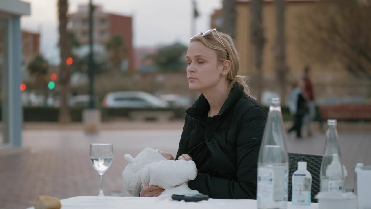 Free Stock Video Sitting At A Cafe Table With Her Baby Live Wallpaper