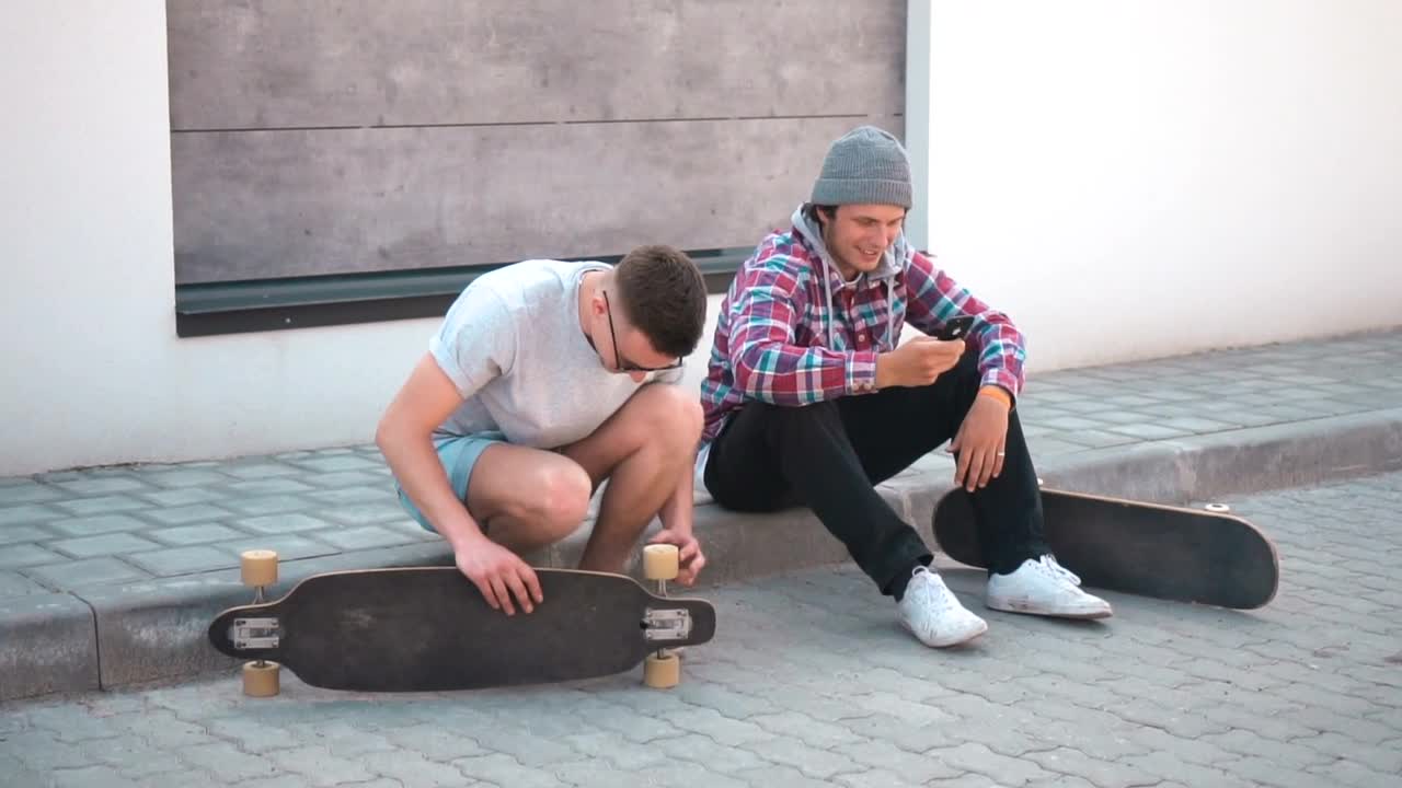 Free Stock Video Skateboarder Fixing His Board Live Wallpaper