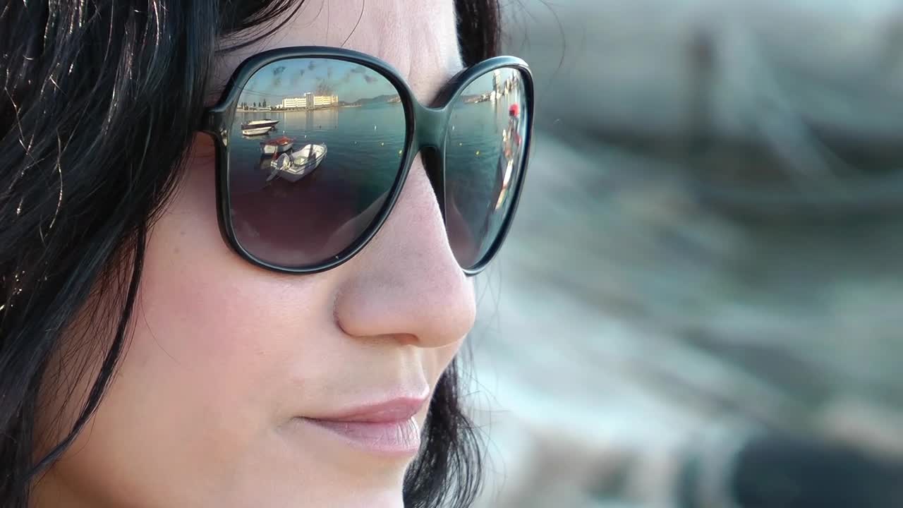 Free Stock Video Relaxed Woman Wearing Glasses By The Seashore Live Wallpaper