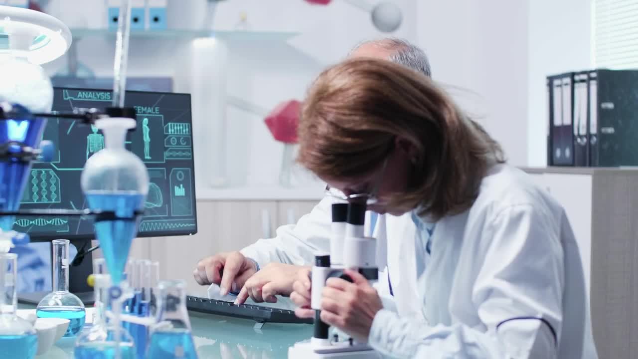 Free Stock Video Research Scientists Collaborate In Modern Lab Live Wallpaper