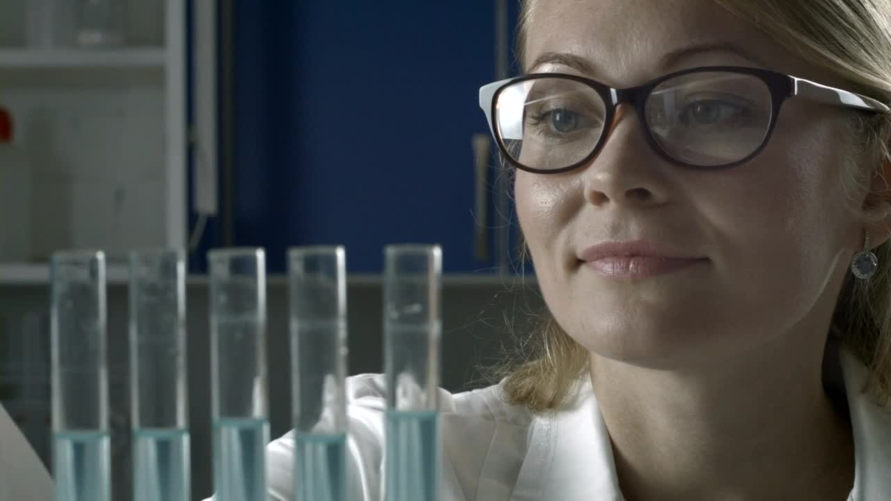 Free Stock Video Researcher Adding Blue Liquid To Test Tubes Live Wallpaper