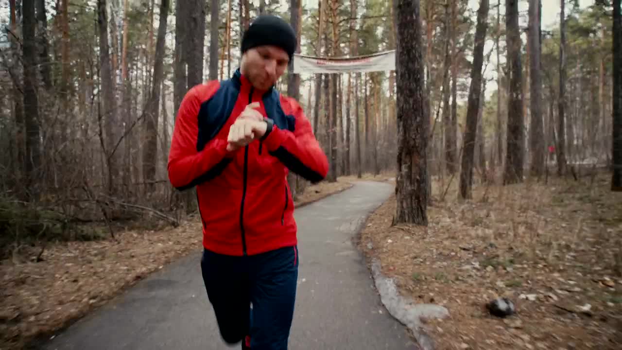 Free Stock Video Runner In Forest Checks Heart Rate On Smartwatch Live Wallpaper