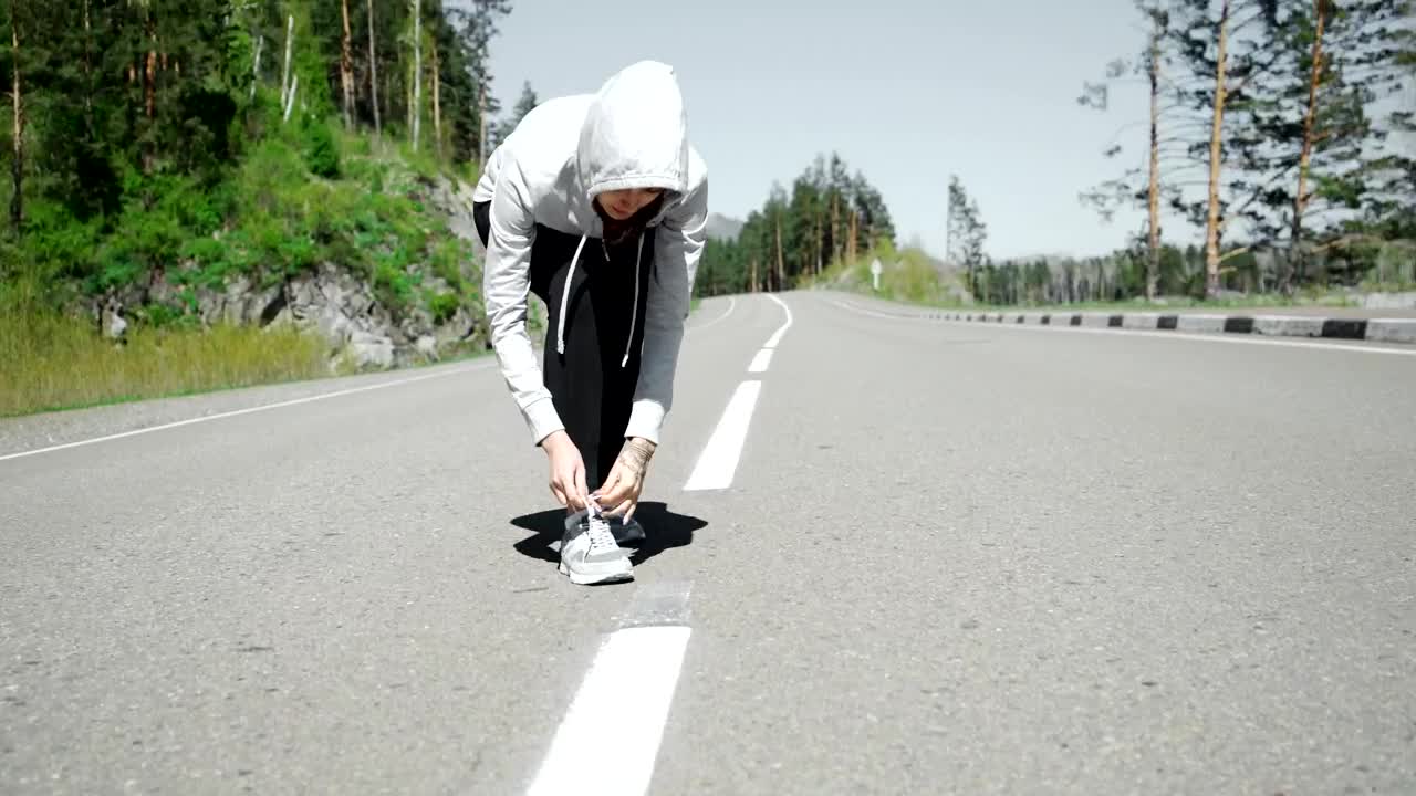 Free Stock Video Runner Ties Laces Before Starting Jog On Mountain Road Live Wallpaper