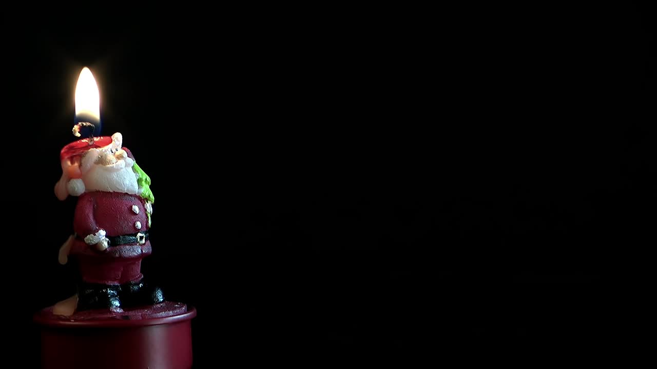Free Stock Video Santa Claus Shaped Candle On Dark Background Live Wallpaper