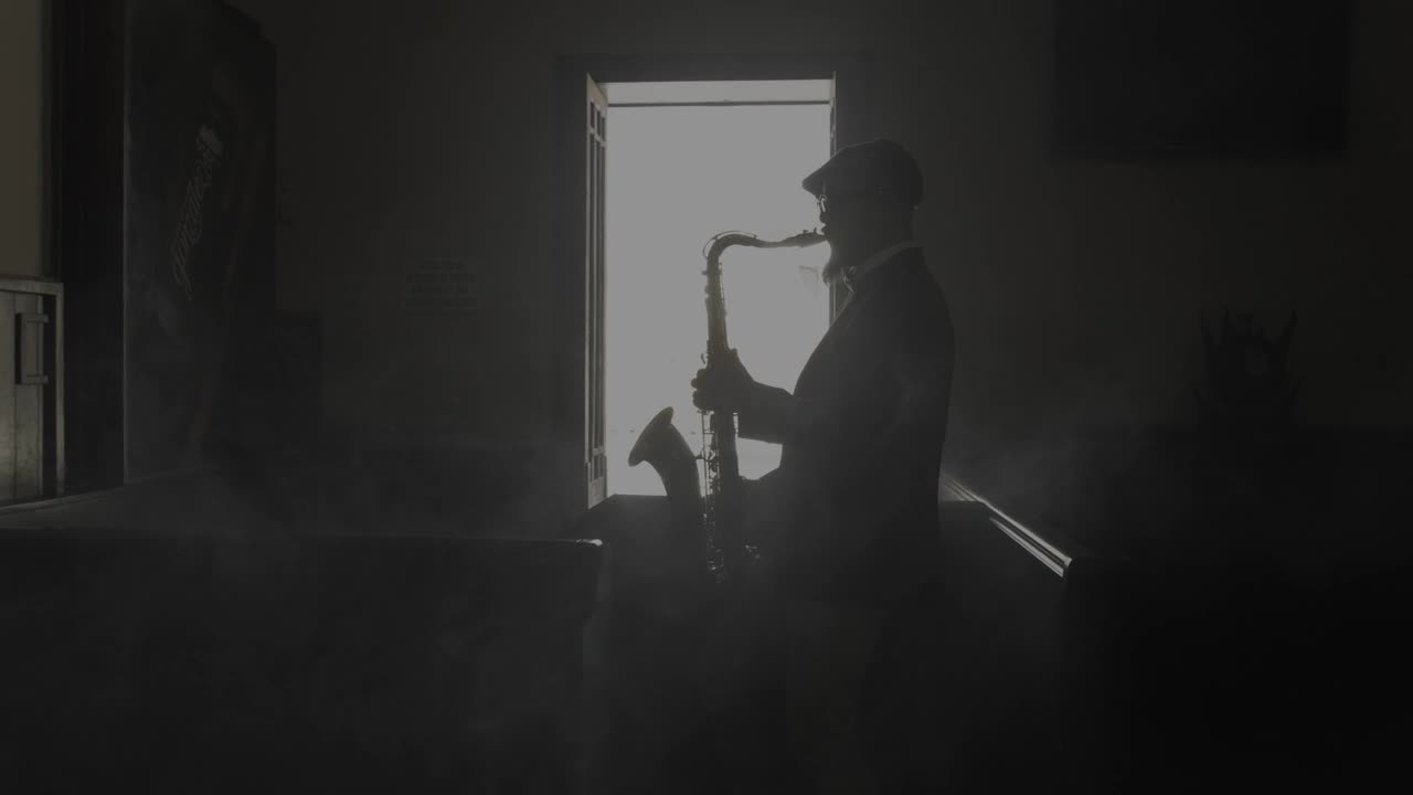 Free Stock Video Saxophonist Silhouette Playing Music In A Dark Room Live Wallpaper