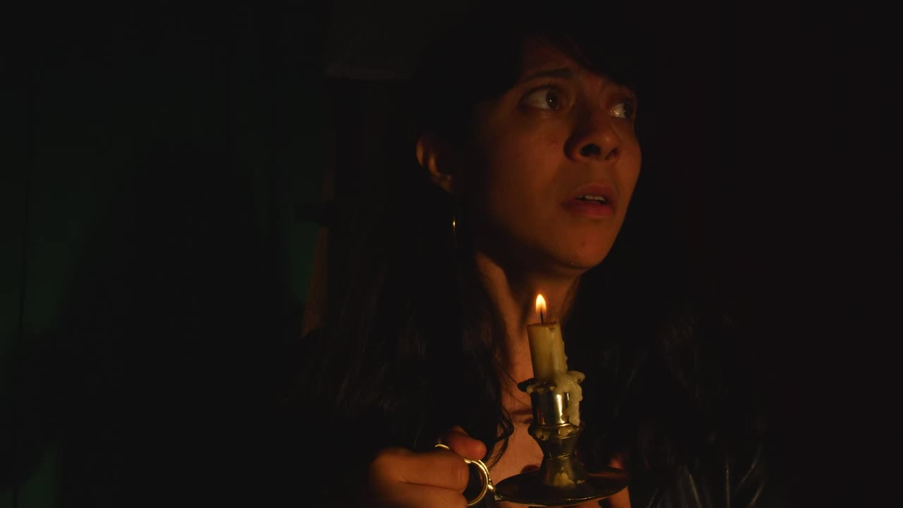 Free Stock Video Scared Woman In A Dark Place With A Candle In Live Wallpaper