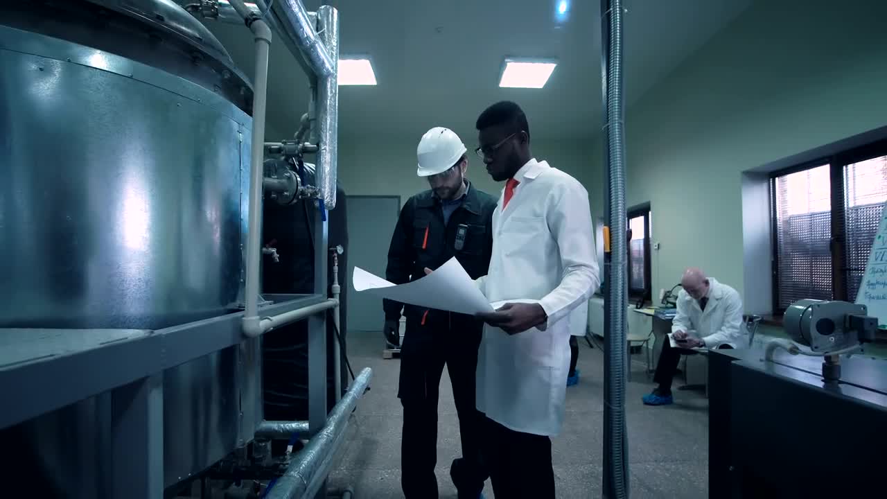 Free Stock Video Scientist Walking Through Lab With A Blueprint Live Wallpaper