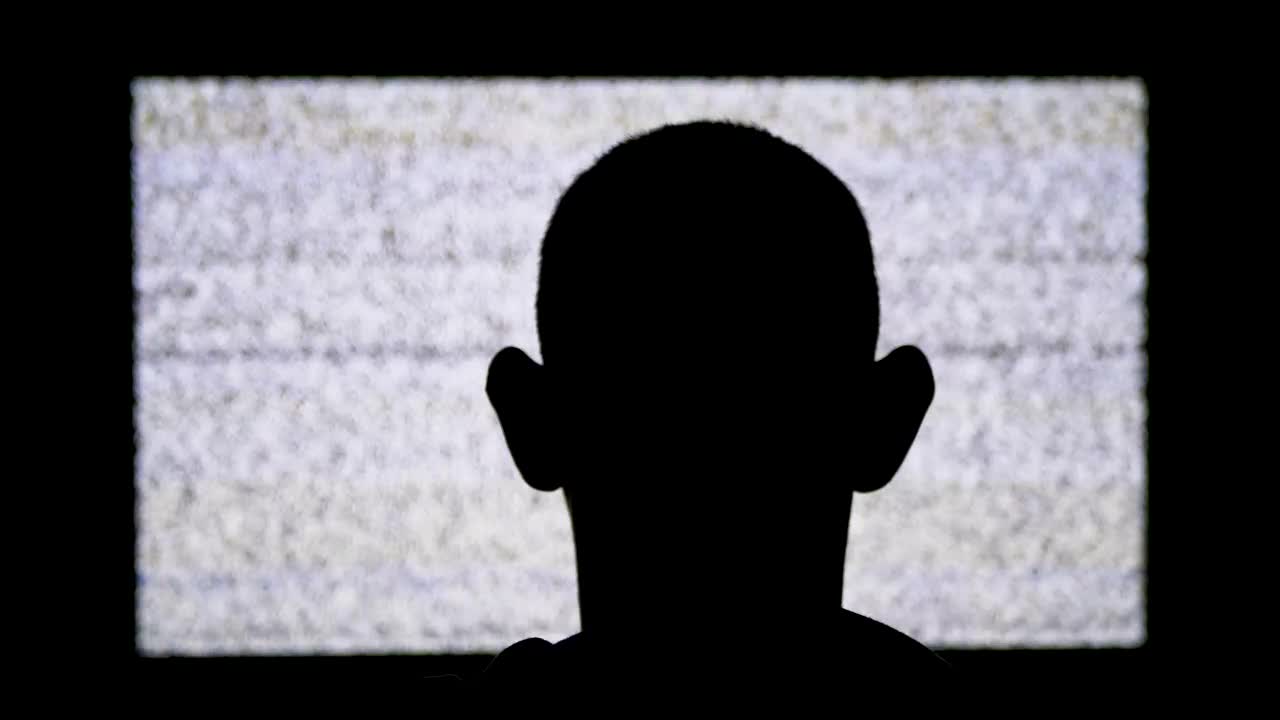 Free Stock Video Silhouette Of A Man In Front Of A Tv With Live Wallpaper