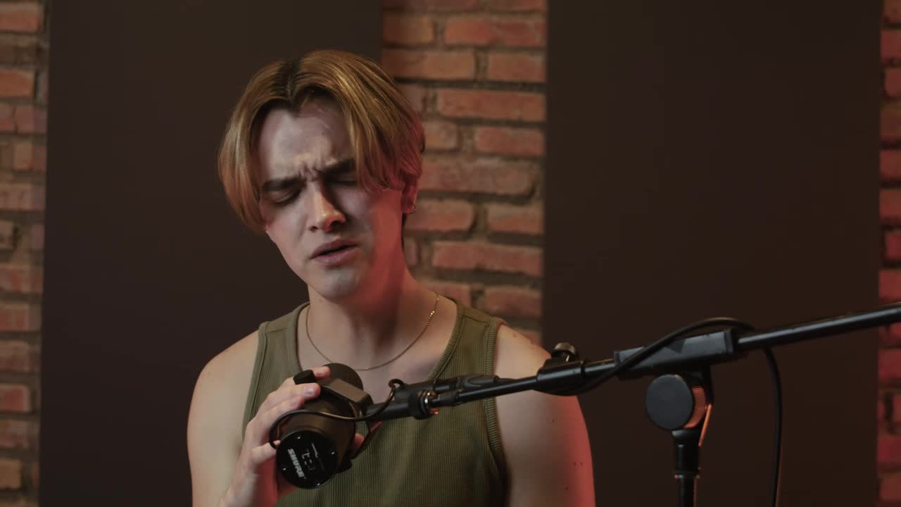 Free Stock Video Singer Recording Vocals In A Studio Booth Live Wallpaper