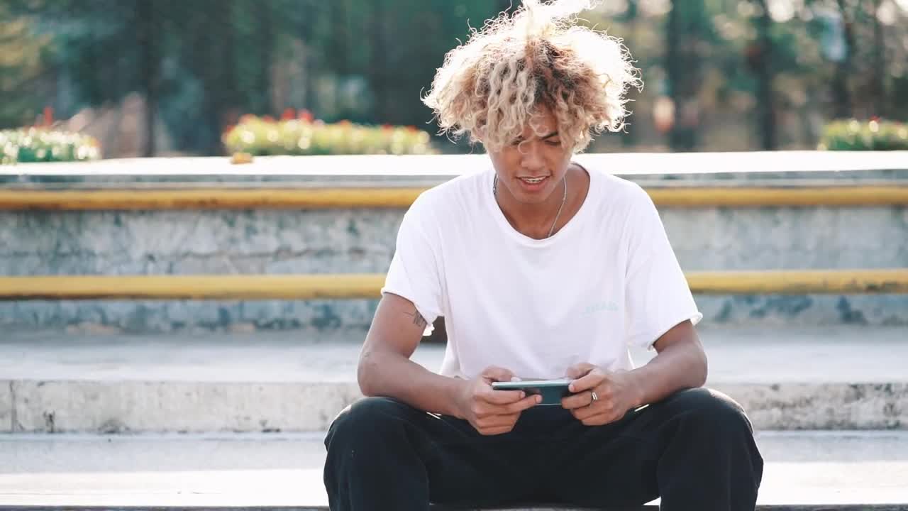 Free Video Stock Skater Texting And Looking At The Camera Live Wallpaper
