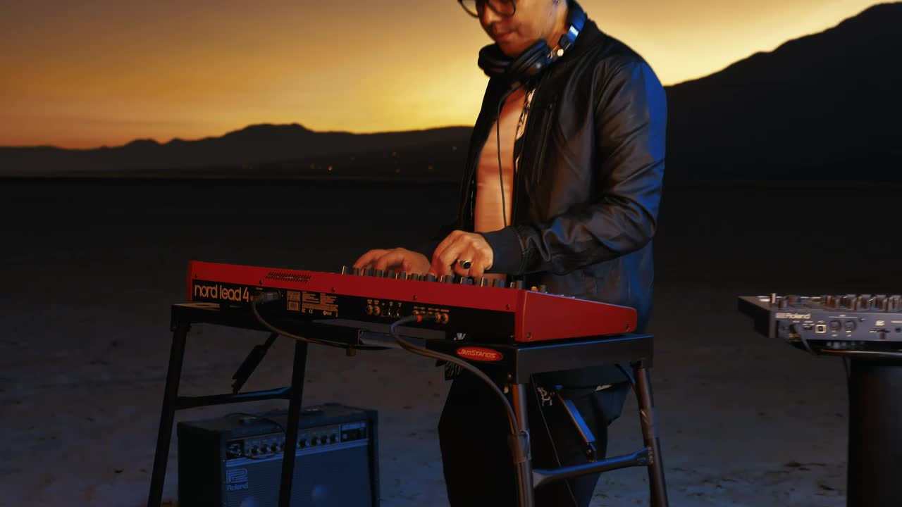 Free Video Stock Skilled Dj Playing With His Equipment In A Huge Desert Live Wallpaper