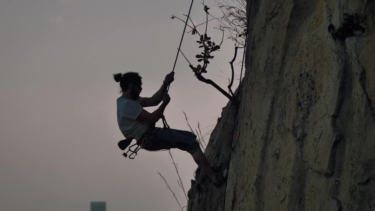Free Video Stock Skilled Mountaineer Descending From A Mountain With A Rope Live Wallpaper
