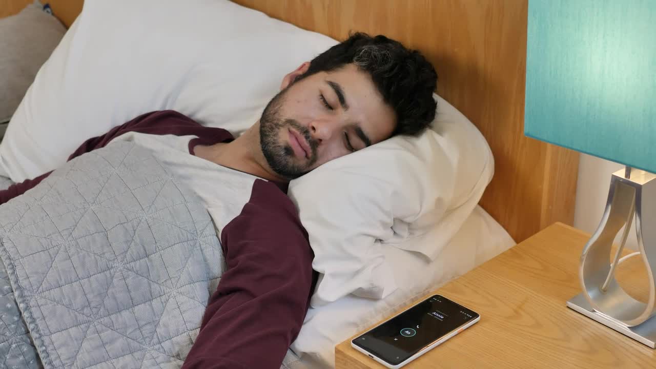 Free Video Stock Sleeping Man Is Awakened By His Cell Phone Alarm Live Wallpaper