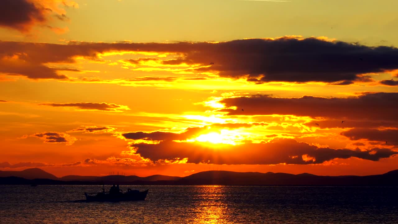 Free Video Stock Small Fishing Boat Crossing The Sunset Live Wallpaper