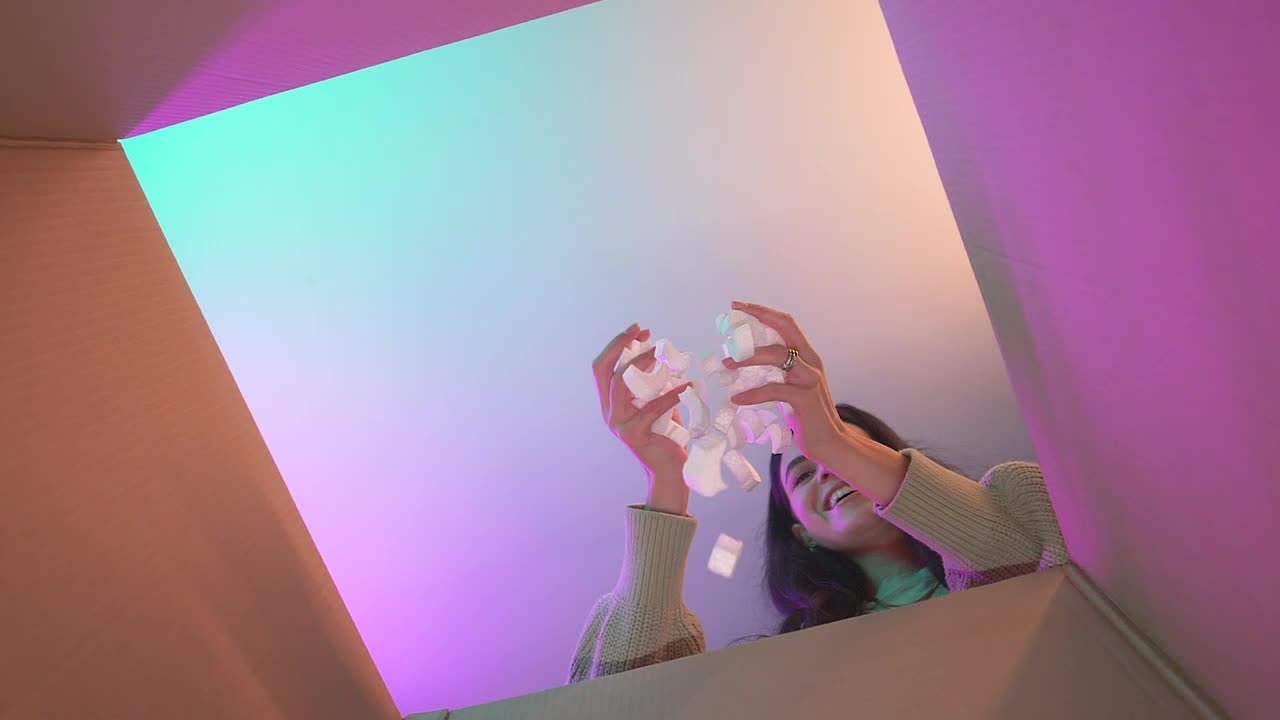 Free Video Stock Smiling Girl Putting Packing Filler In A Box Live Wallpaper