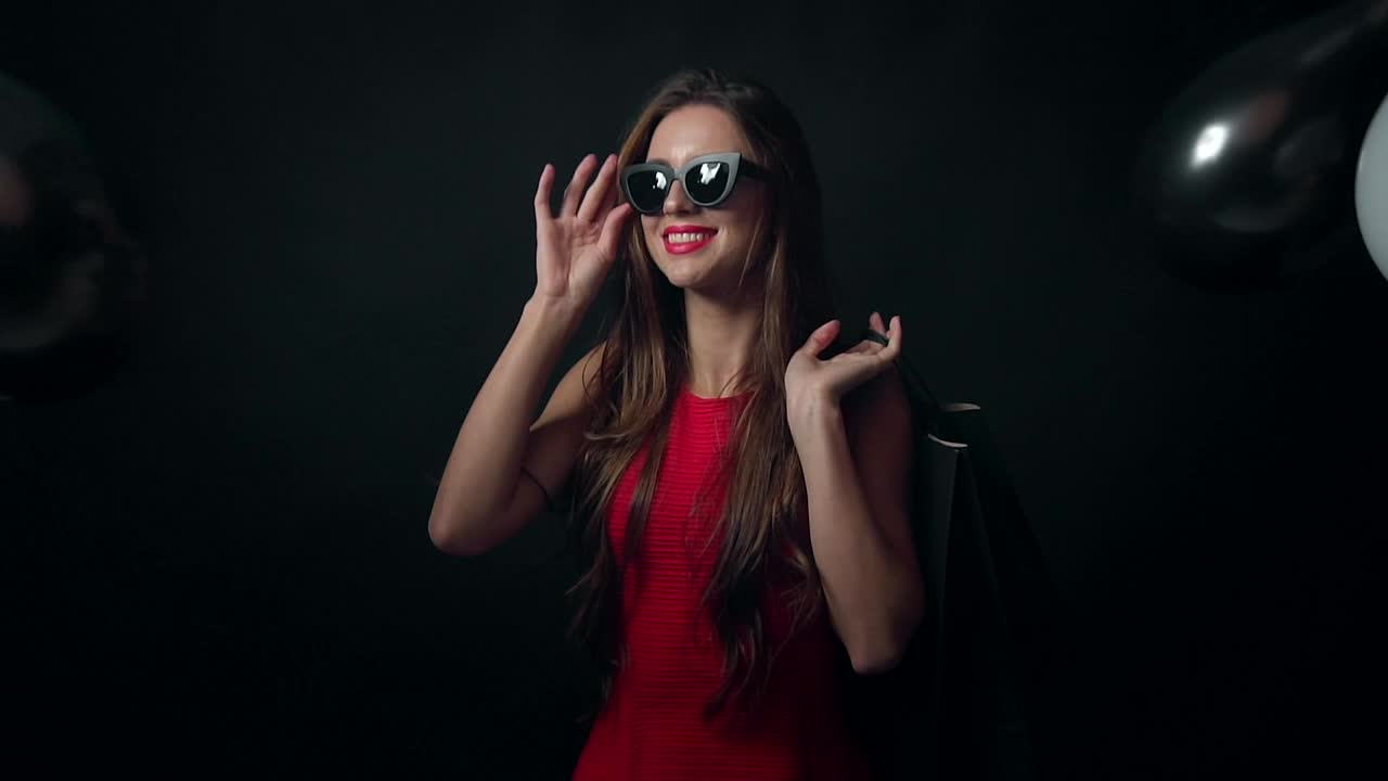 Free Video Stock Smiling Model With Falling Balloons On Black Background Live Wallpaper