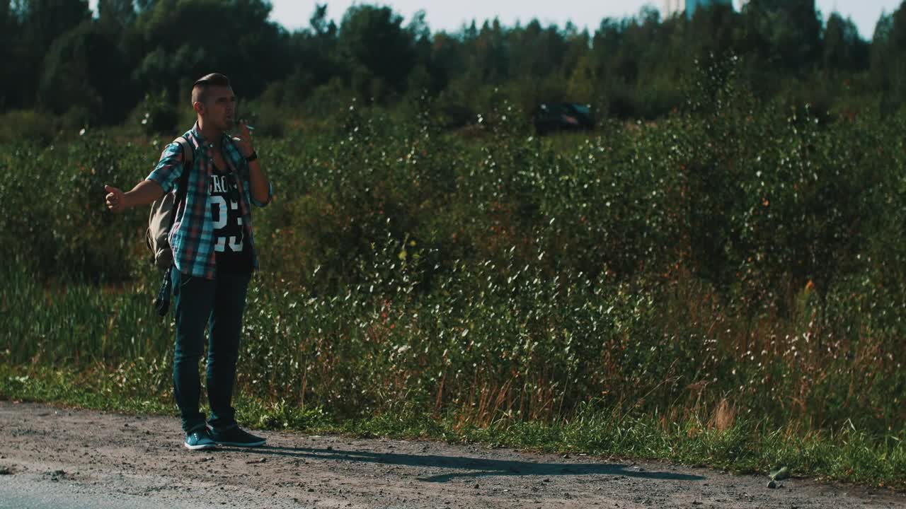 Free Video Stock Smoking Man Hitchhiking In A Rural Area Live Wallpaper