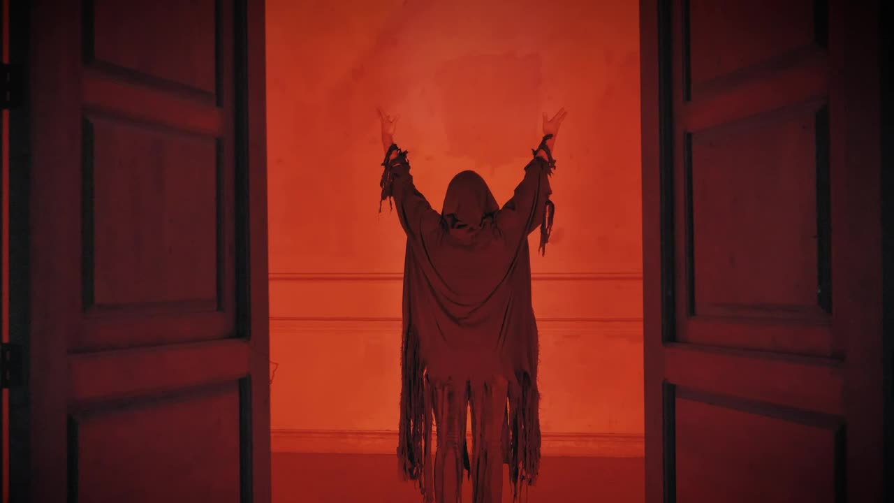 Free Video Stock Sneaky Robed Person With Arms Up Under A Red Light Live Wallpaper