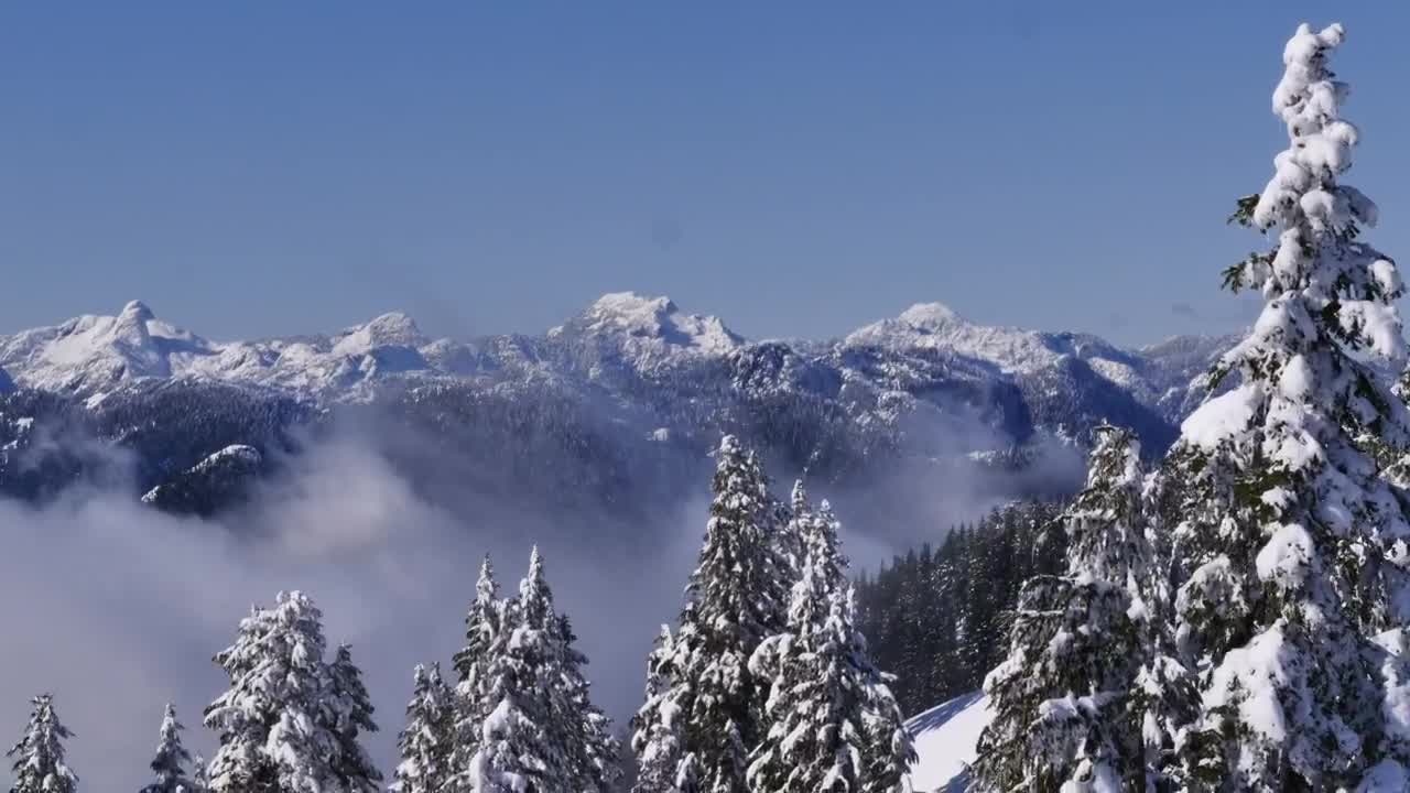 Free Video Stock Snowy Mountain Range Seen Above The Clouds Live Wallpaper