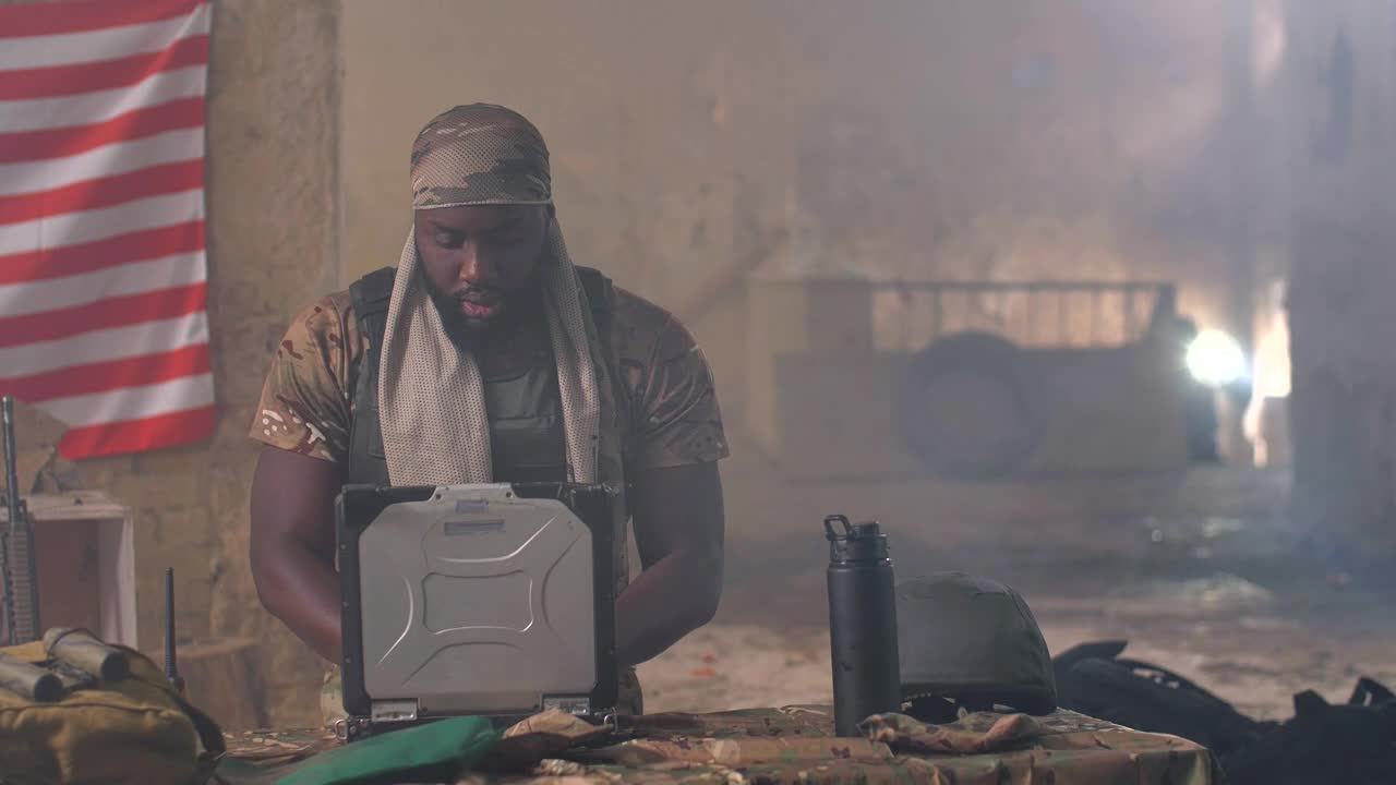 Free Video Stock Soldier Using A Laptop In The Field Live Wallpaper