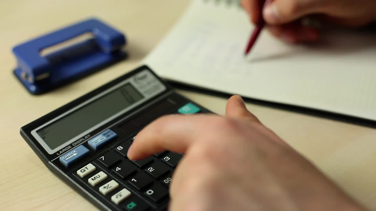 Free Video Stock Solving Accounts In A Notebook With A Calculator Live Wallpaper