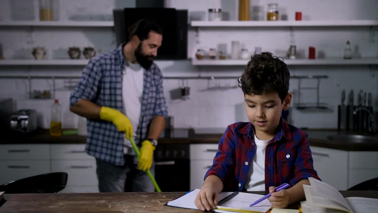 Free Video Stock Son Doing Homework While His Father Cleans Live Wallpaper