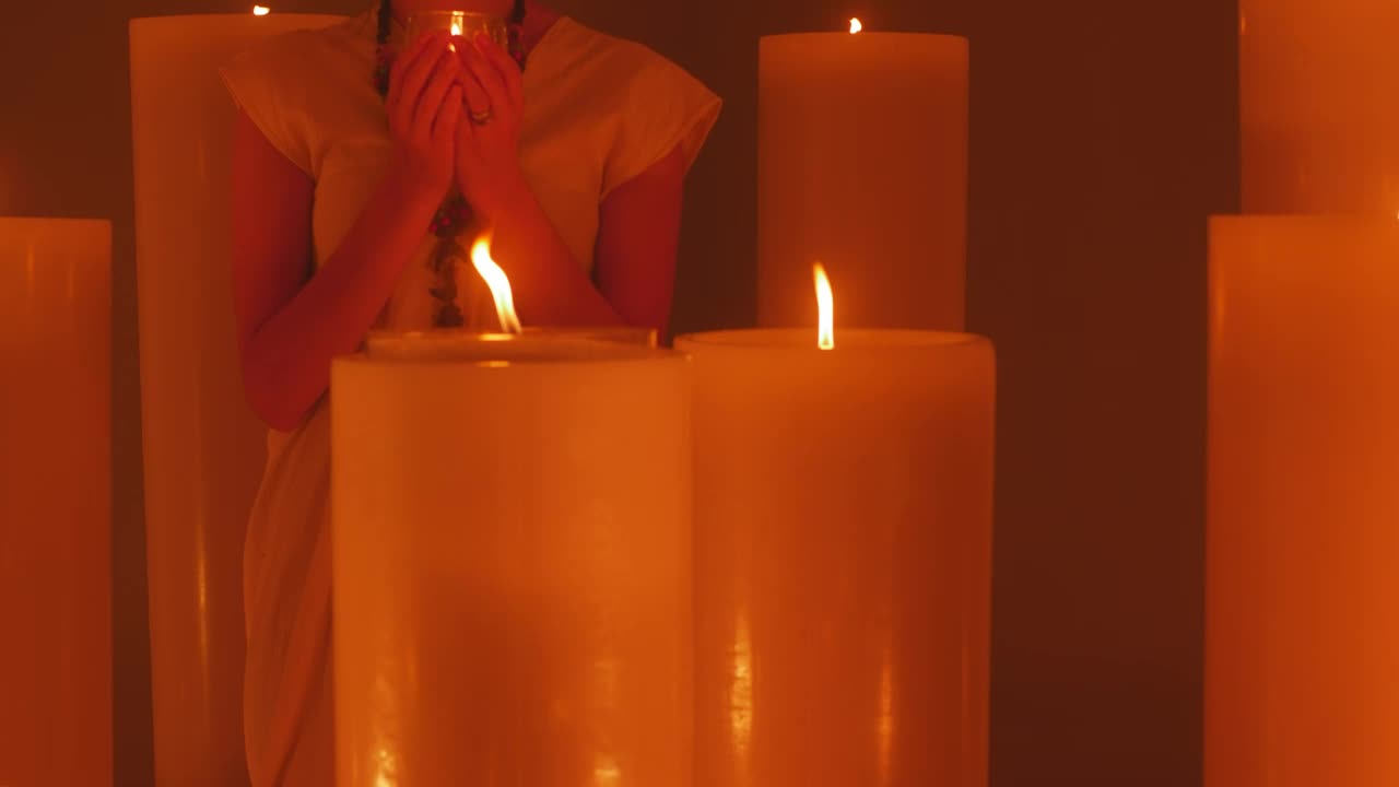 Free Video Stock Spiritual Woman Meditating Among Many Candles Live Wallpaper