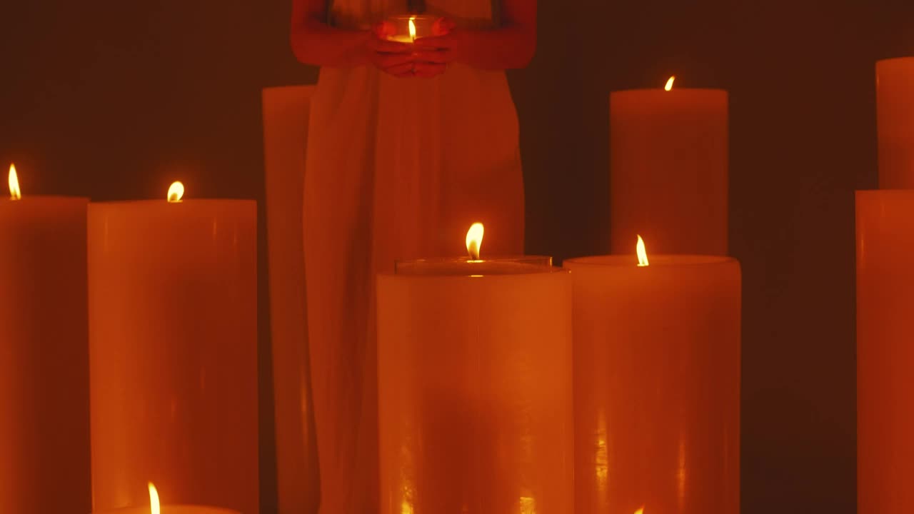 Free Video Stock Spiritual Woman Surrounded By Lots Of Candles Live Wallpaper