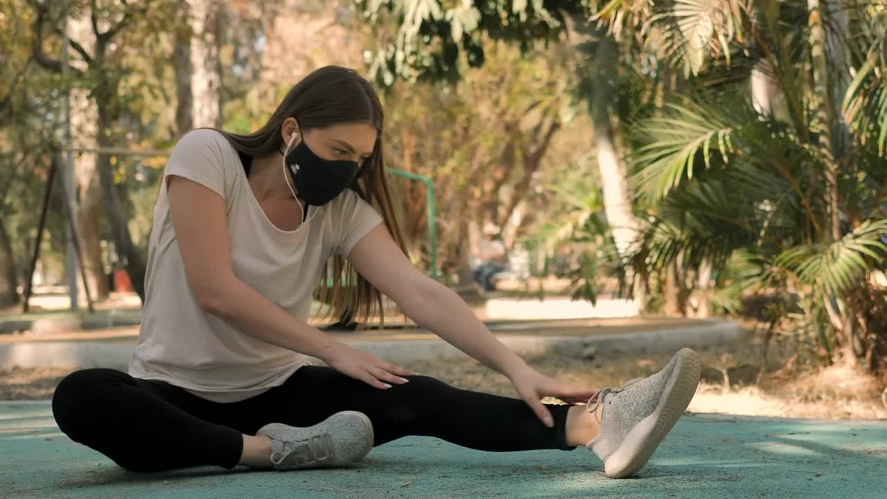 Free Video Stock Sportswoman Stretching With A Face Mask Live Wallpaper