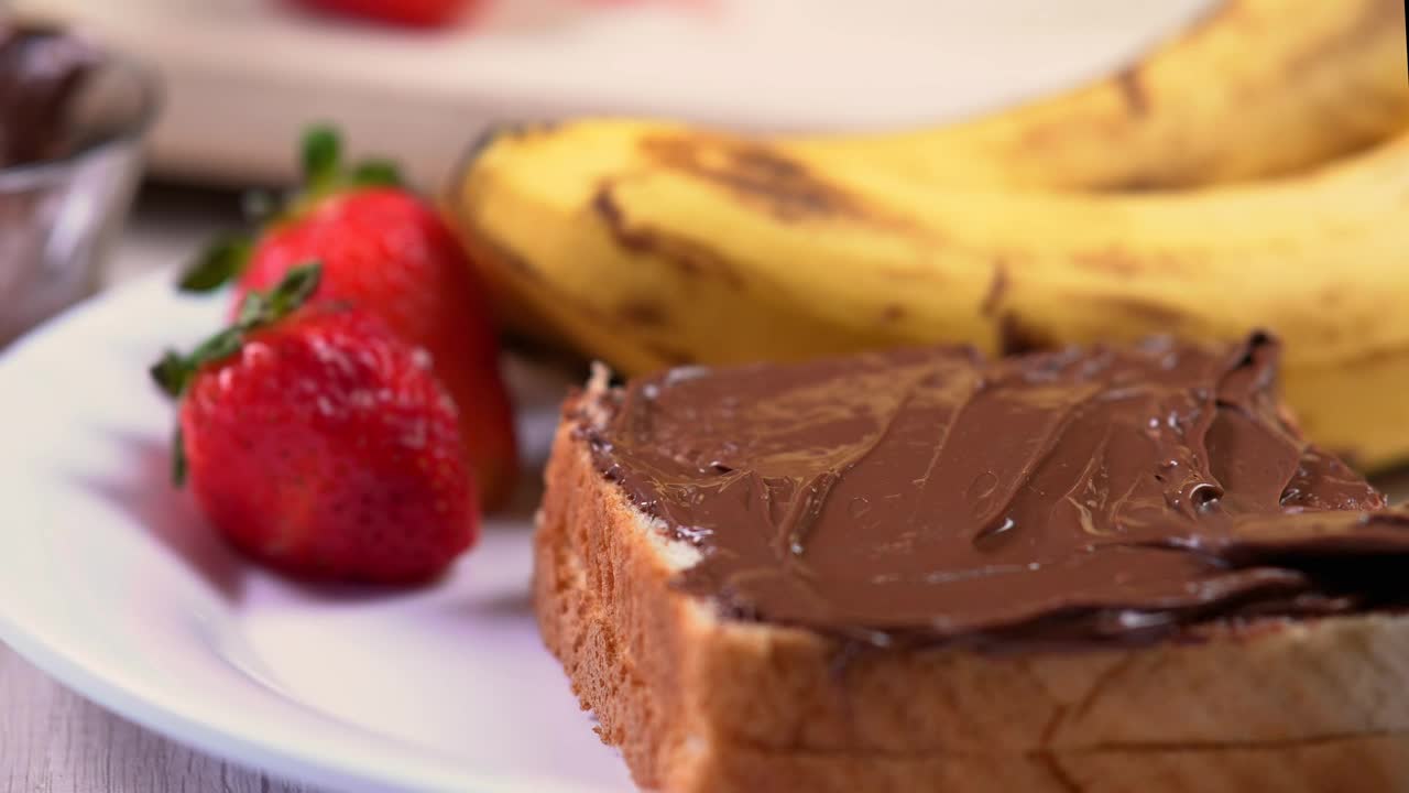 Free Video Stock Spreading Hazelnut Cream On White Bread Live Wallpaper