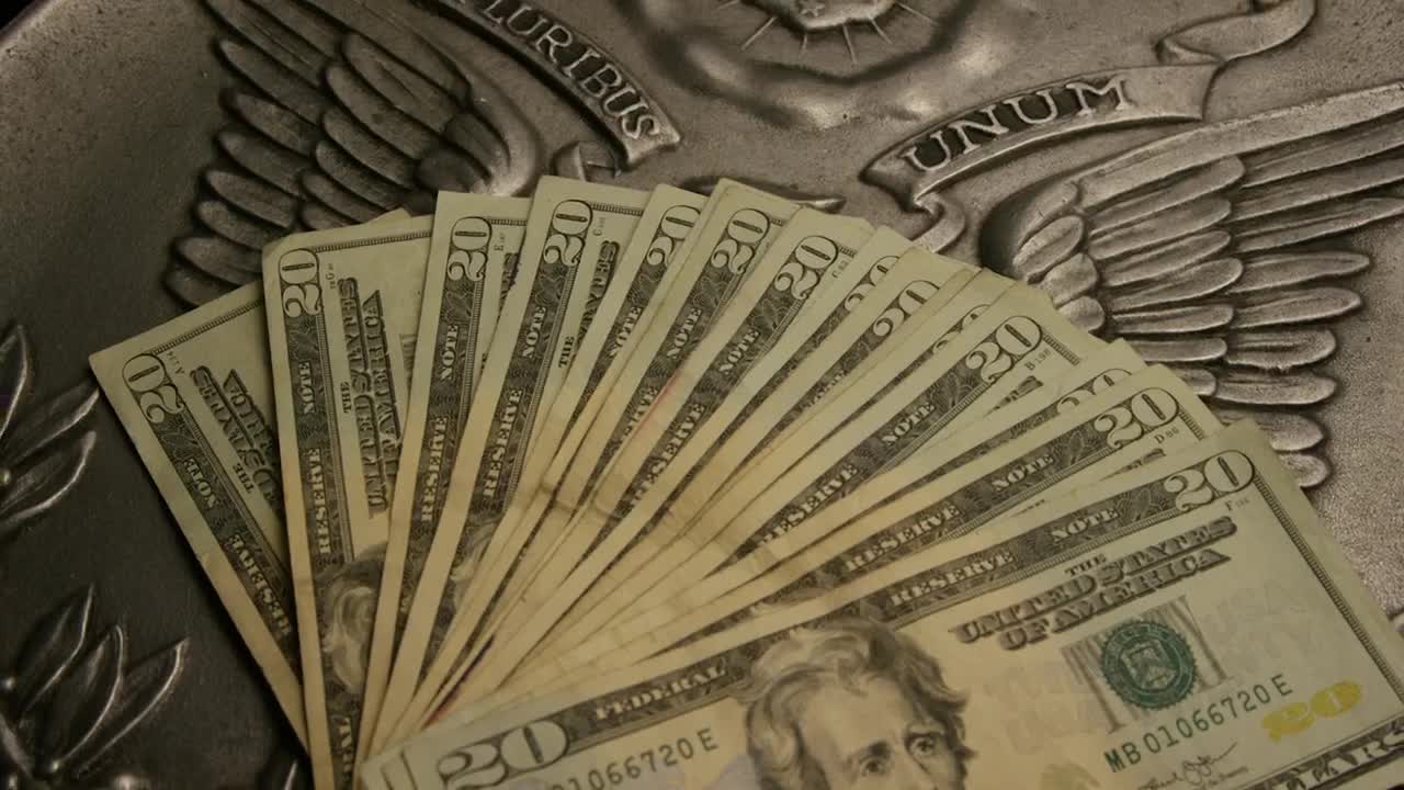 Free Video Stock Stack Of Dollar Bills Of  Over A Country Emblem Live Wallpaper