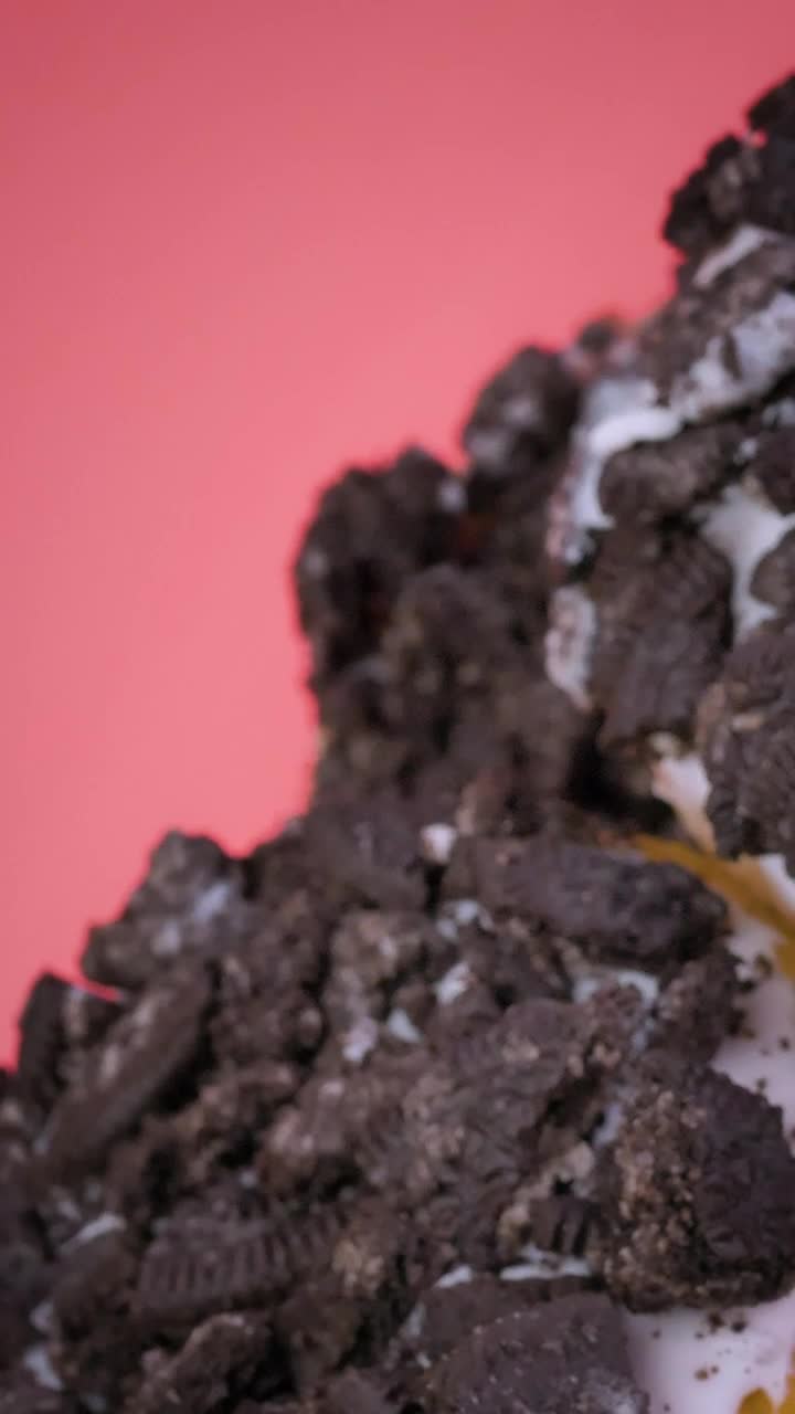 Free Video Stock Stacking Donuts With Cookie Pieces On A Pink Background Live Wallpaper