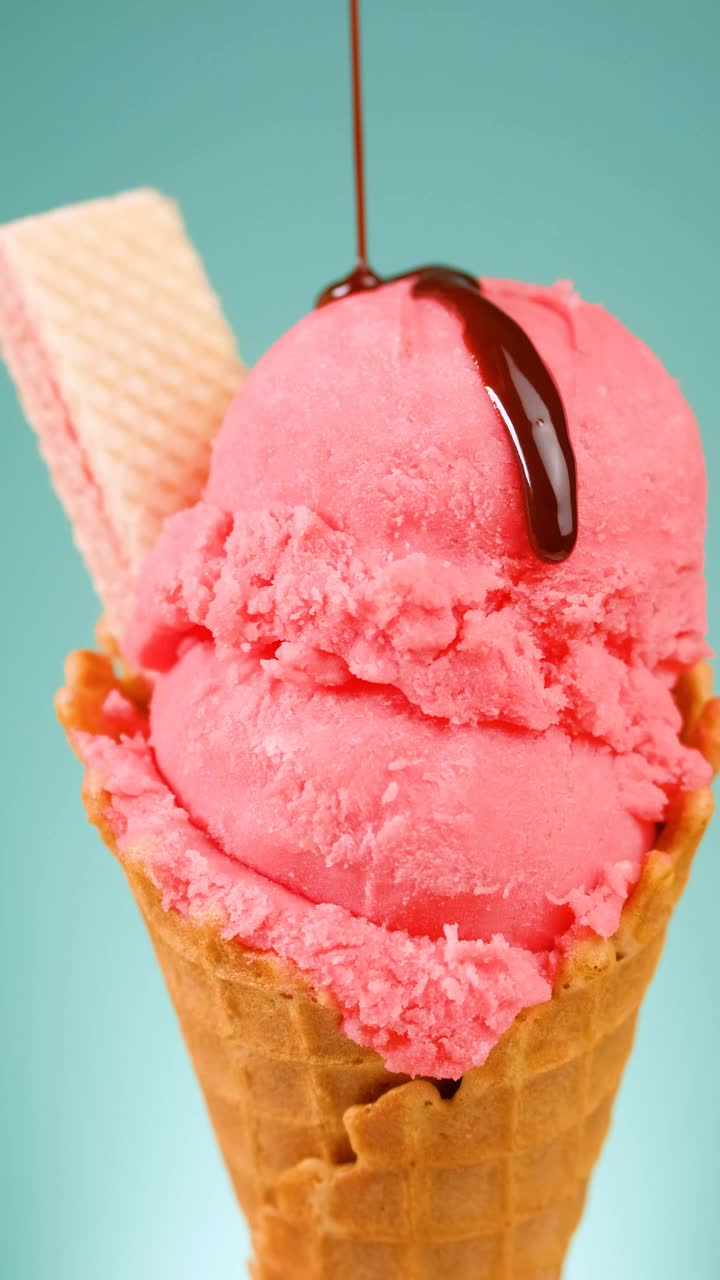 Free Video Stock Strawberry Ice Cream Cone With Chocolate Syrup On A Blue Live Wallpaper