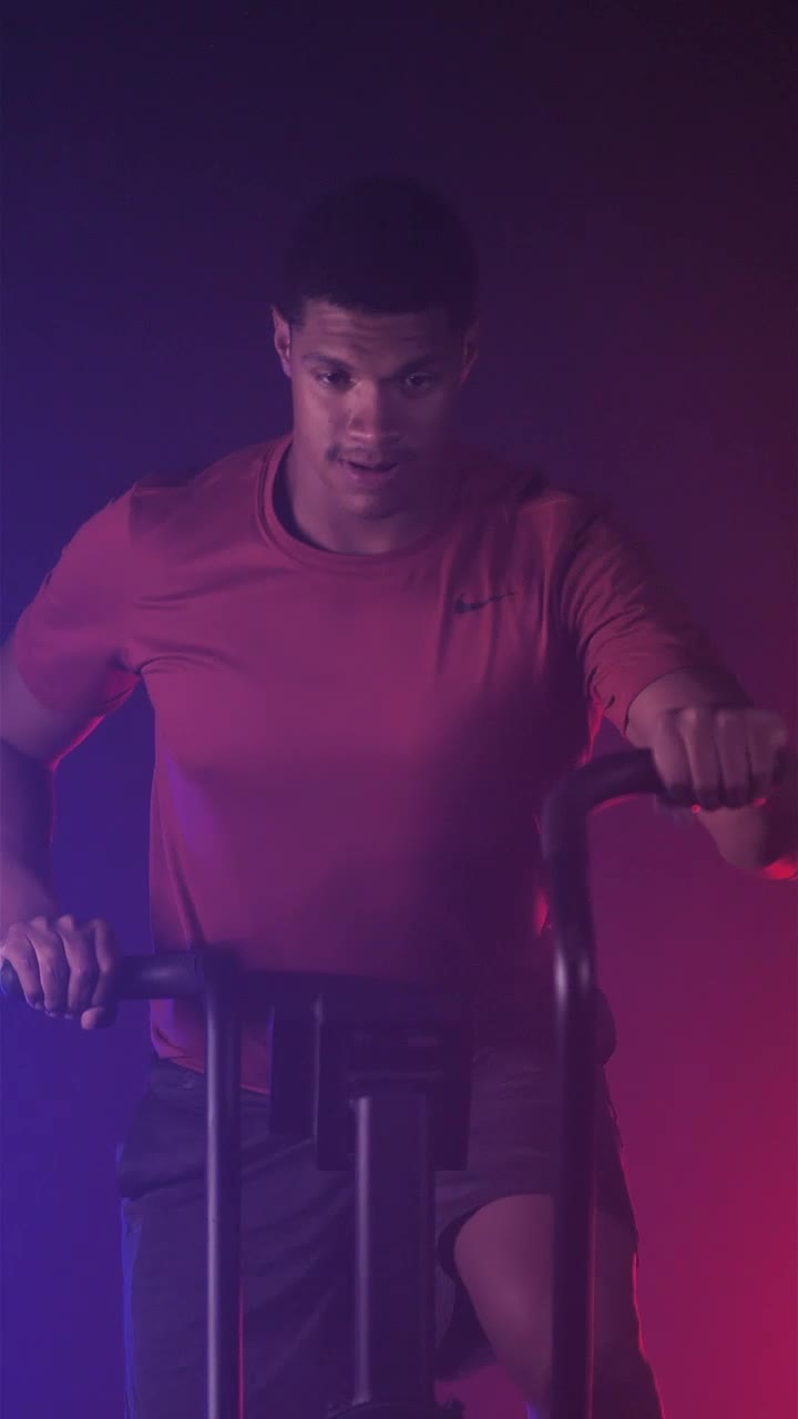 Free Video Stock Strong Man Exercising With A Fitness Air Bike Live Wallpaper