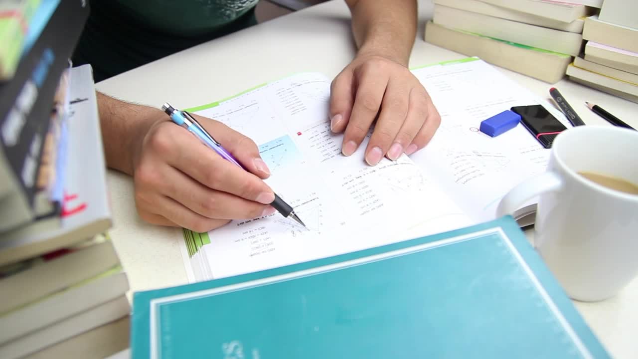 Free Video Stock Student Doing Homework On A Desk With Many Books Live Wallpaper