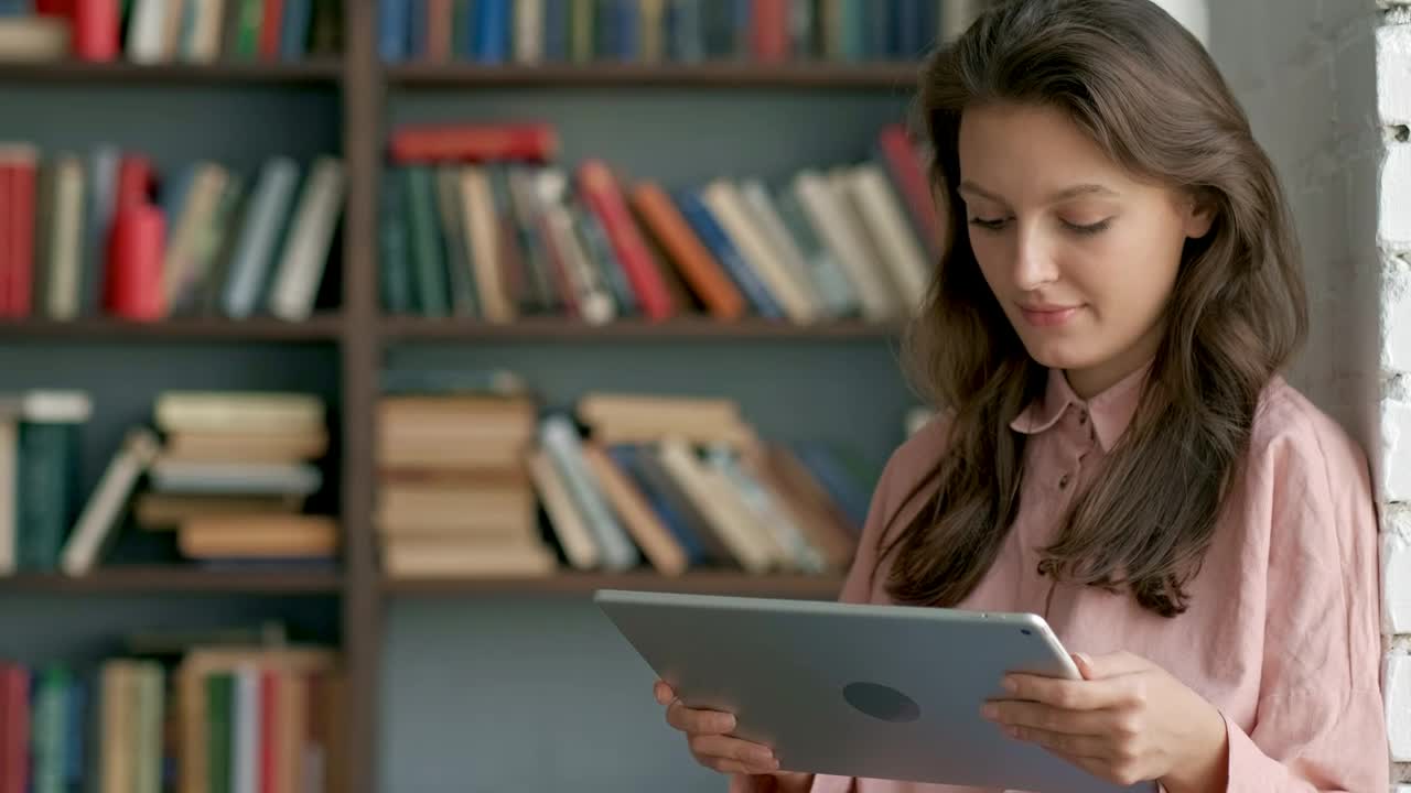 Free Video Stock Student Reading On A Tablet At A Library Live Wallpaper