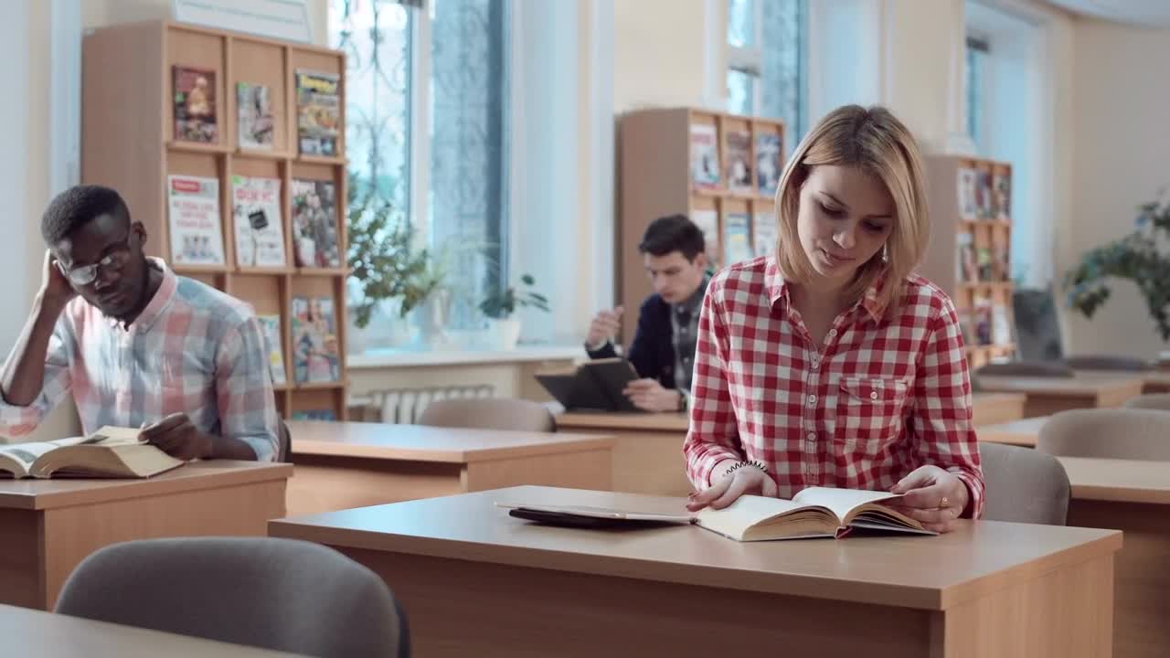 Free Video Stock Student With Book And Tablet In The Library Live Wallpaper