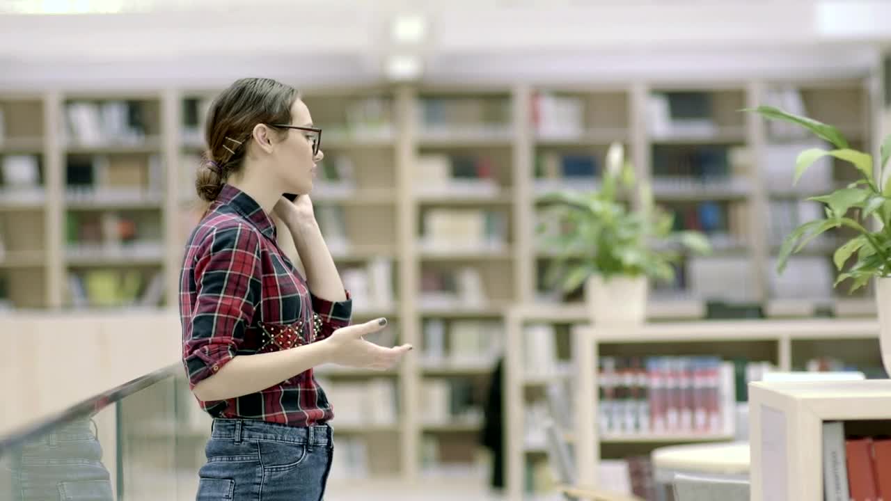 Free Video Stock Student Woman Talking On The Phone In The Library Live Wallpaper