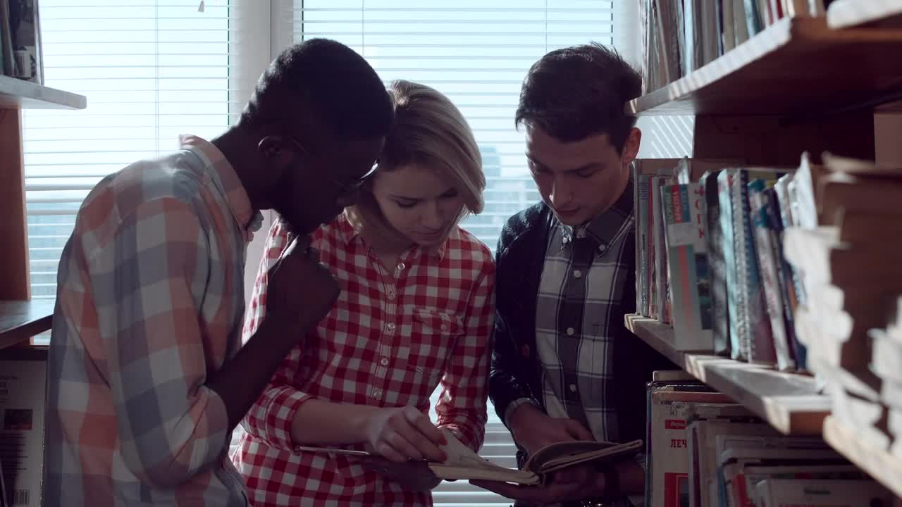 Free Video Stock Students Are Discussing Books In The Library Live Wallpaper